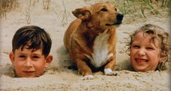 Prince Charles and Princess Anne in the sand with 