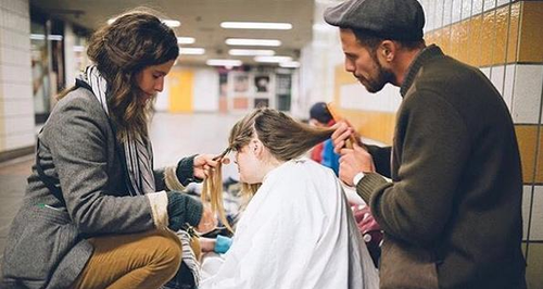 Josh Coombes cutting a homeless ladies hair
